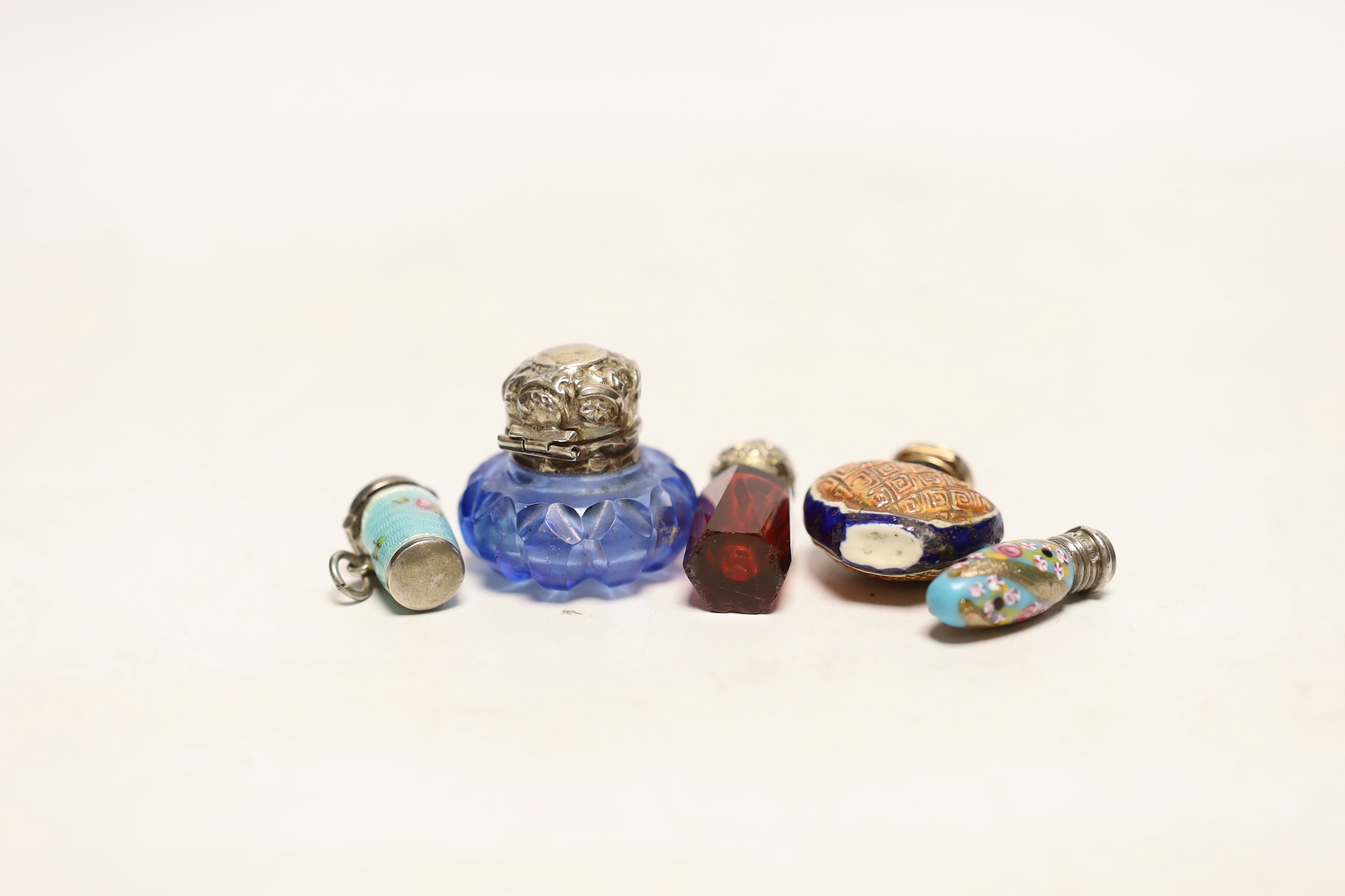 An Edwardian small silver and enamel scent bottle Birmingham, 1901, 29mm, two other small scent bottles and an enamelled thimble? holder.